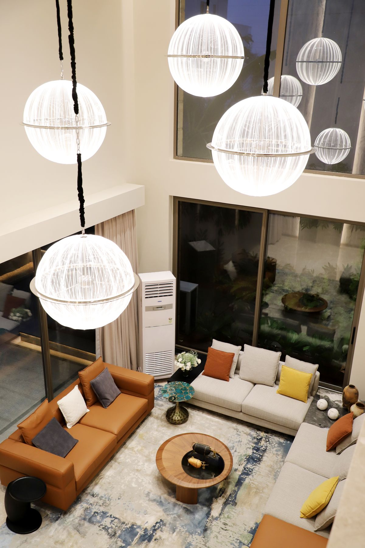 Modern home interior featuring illuminated sculptural pendant lights